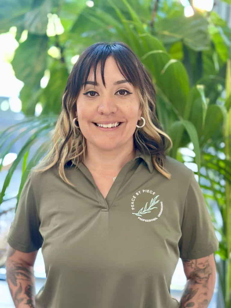 Peace by Piece organizer Tara wearing an olive green polo shirt with the company's logo.